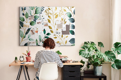 Tablero de corcho decorativo con diseño de hojas doradas sobre fondo claro