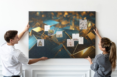 Pizarra de corcho con diseño de formas geométricas en tonos dorados y azules