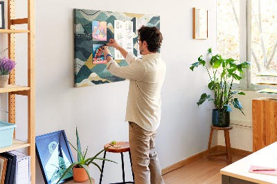 Tablero de corcho decorado con patrones abstractos de paisajes montañosos en colores