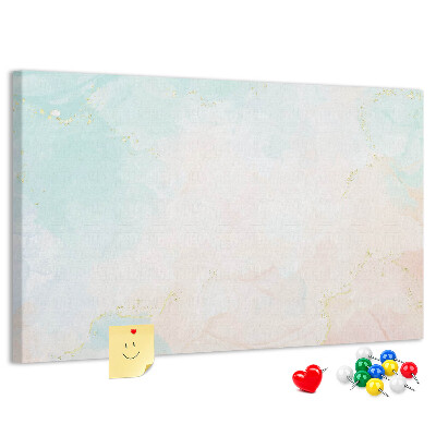 Tablero de corcho decorado con delicados lunares en tonos pastel y detalles dorados