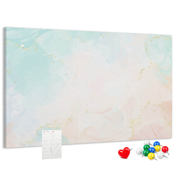 Tablero de corcho decorado con delicados lunares en tonos pastel y detalles dorados