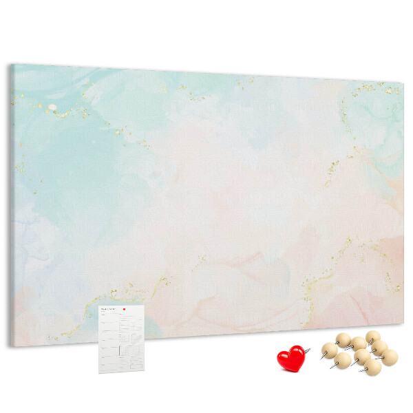 Tablero de corcho decorado con delicados lunares en tonos pastel y detalles dorados
