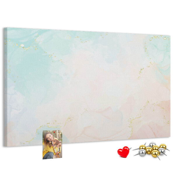 Tablero de corcho decorado con delicados lunares en tonos pastel y detalles dorados