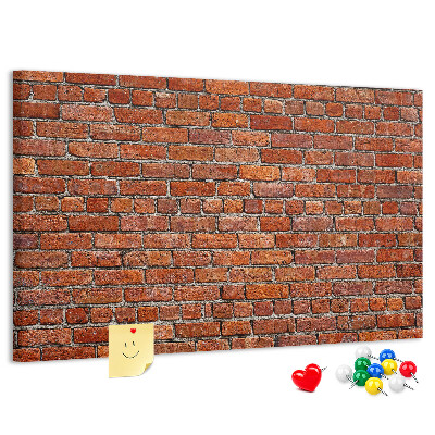 Tablero de anuncios Pared de ladrillo en tonos cálidos.