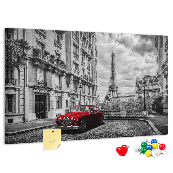 Tablero de anuncios Un coche rojo con París al fondo.