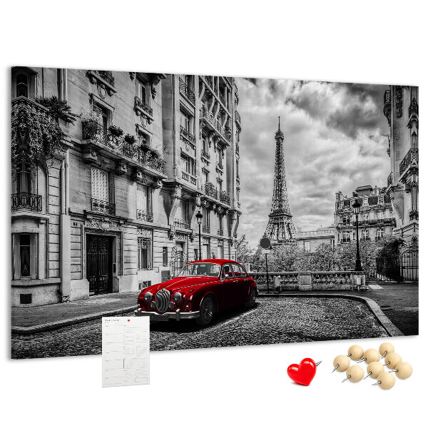 Tablero de anuncios Un coche rojo con París al fondo.