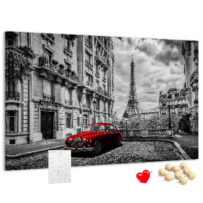 Tablero de anuncios Un coche rojo con París al fondo.