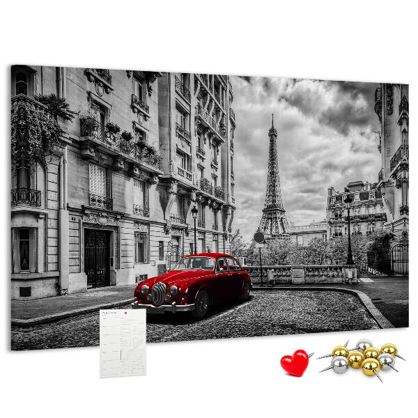 Tablero de anuncios Un coche rojo con París al fondo.