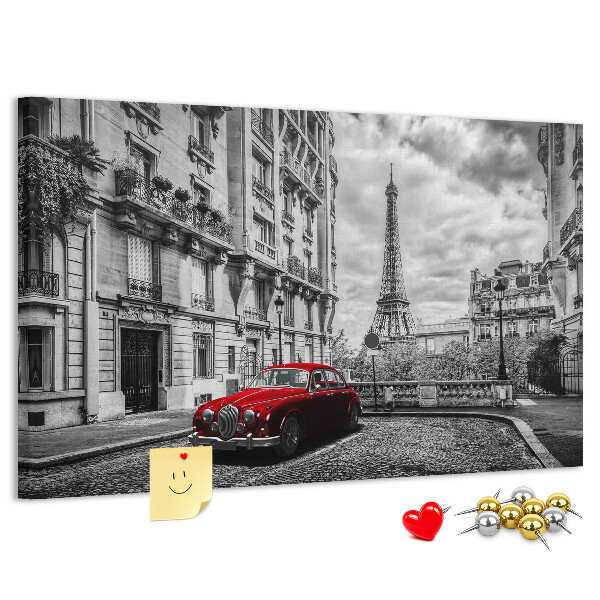 Tablero de anuncios Un coche rojo con París al fondo.