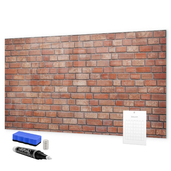 Pizarra borrable de cristal con imanes Un tablero de notas en una pared de ladrillos.